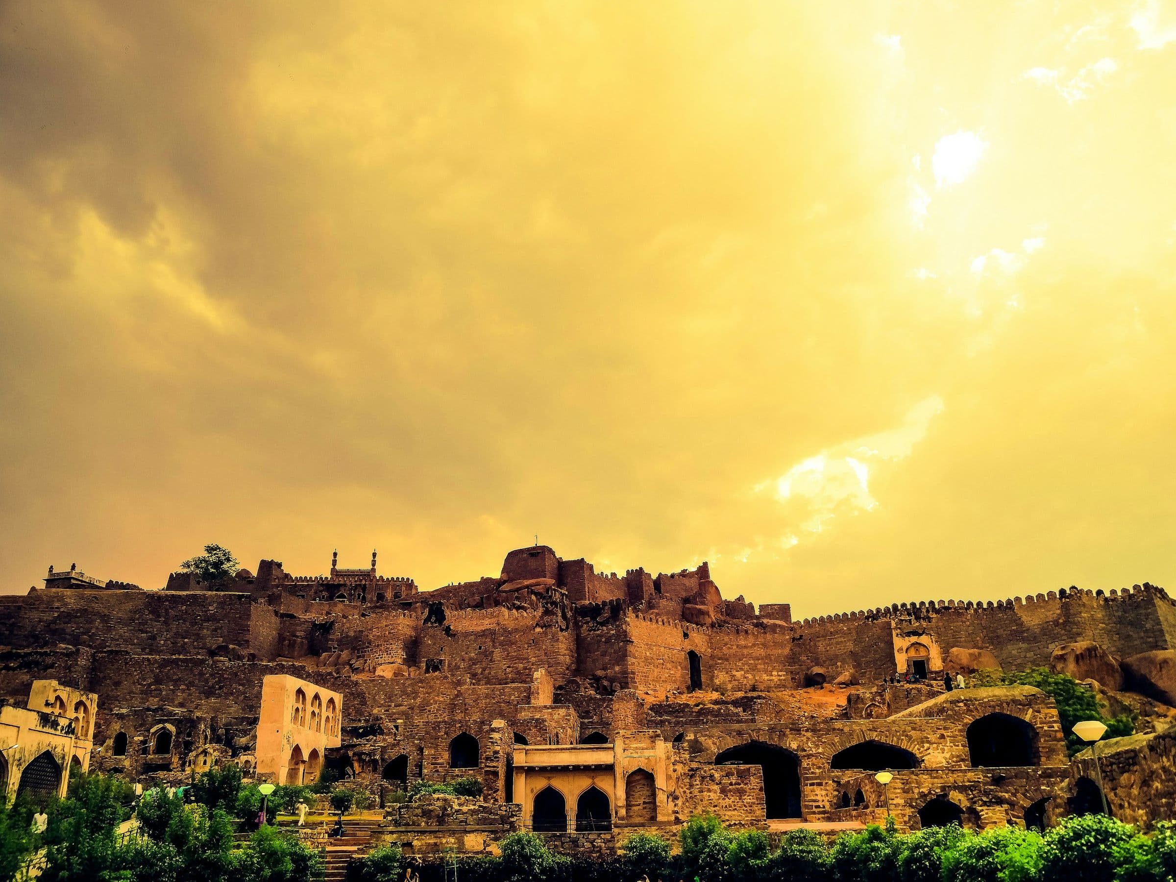 Golconda Fort under a golden evening sky